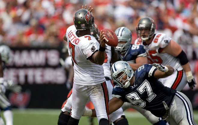 Buccaneers' quarterback  Byron  Leftwich   manages  to  get  a  pass  off  before  the  Cowboys  defensive  player   Jason  Hatcher  (97)  manages   to  make  the  defensive  play.     picture  appears  courtesy  of   getty  images/  J Meric   ......................... 