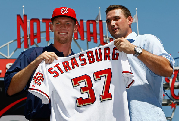 Steven Strasburg (L), the overall first pick in the 2009 MLB Draft, is presented with his jersey by Nationals third baseman Ryan Zimmerman (R) after being introduced at Nationals Park August 21, 2009 in Washington, DC. Strasburg, a right handed pitcher from San Diego State University, signed with the Nationals earlier this week wth a record contract for an amateur player.