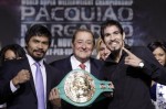 Pacquiao (left) is seen here with Top Rank Boxing promoter Bob Arum (center) alongside Antoni Margarito and the WBC welterweight title belt held by the promoter at their pre-fight conference. picture appears courtesy of Getty Images North America / Steve Shaw ......